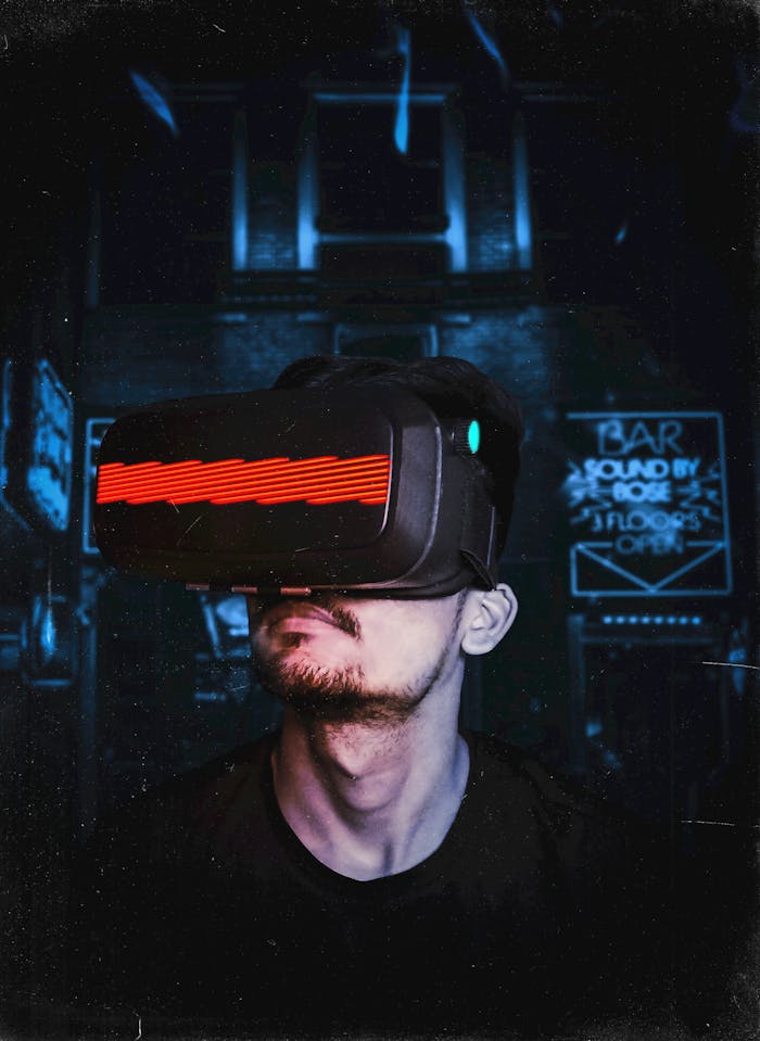 gallery-05 Young man immersed in a virtual reality experience using a VR headset, showcasing futuristic tech in a gaming environment.